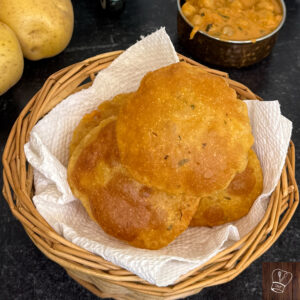 Golden puffed puris frying in hot oil