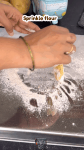 Rolling poori dough evenly with a rolling pin