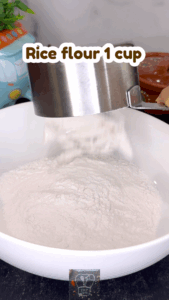 Mixing rice flour, sesame oil, and salt for idiyappam dough